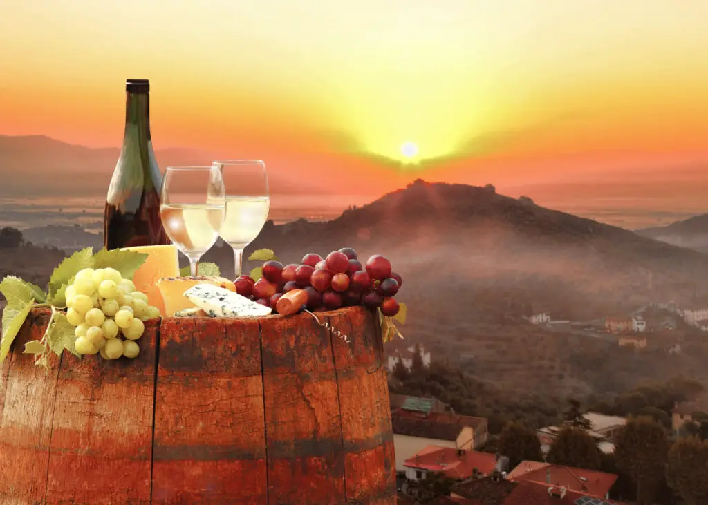 Sunset in Tuscany Italy with wine, cheese, and grapes